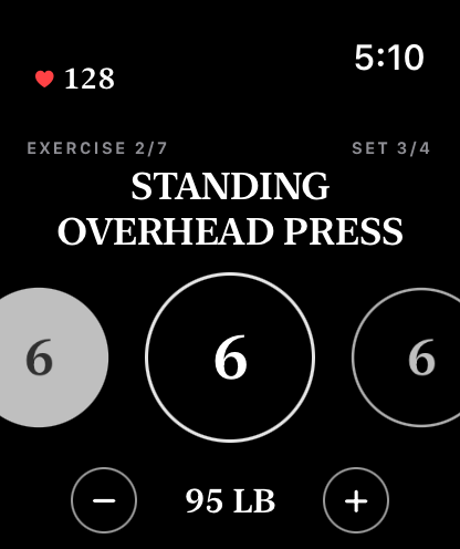 The watch mid-exercise: set circles and the weight, with live heart rate in the corner.