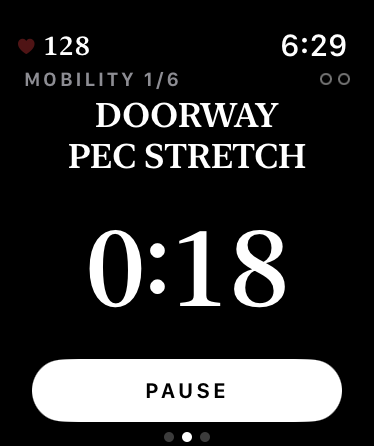 The Doorway Pec Stretch on the watch, mobility one of six, counting down with a Pause button.