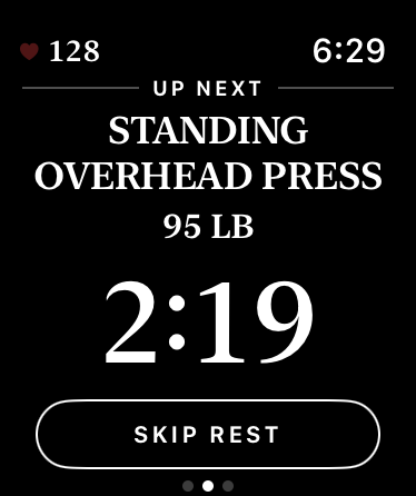 Up Next on the watch: the Standing Overhead Press at 95 lb, over the rest countdown and a Skip Rest button.
